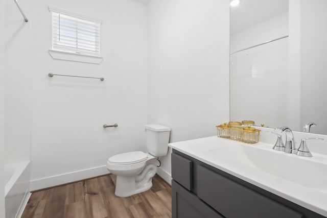 bathroom featuring hardwood / wood-style flooring, vanity, and toilet