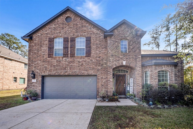 view of front of home with a front yard and a garage