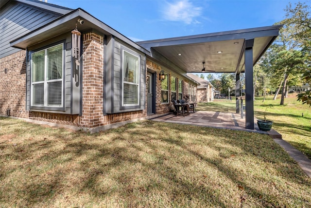 view of property exterior with ceiling fan, a patio area, and a lawn