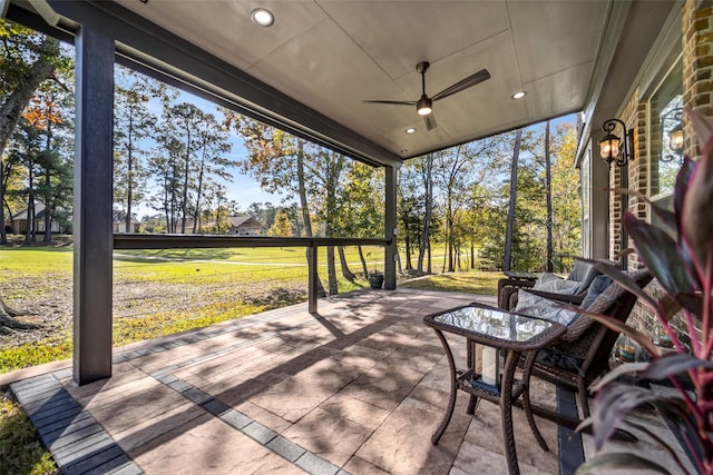 sunroom featuring ceiling fan