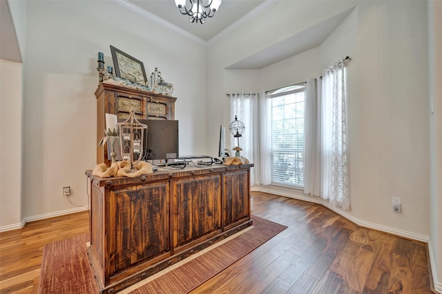 office area featuring hardwood / wood-style floors, an inviting chandelier, crown molding, and a healthy amount of sunlight