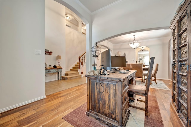 interior space featuring crown molding and light hardwood / wood-style flooring