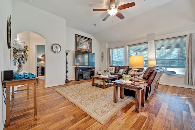 living room with hardwood / wood-style flooring, vaulted ceiling, and ceiling fan