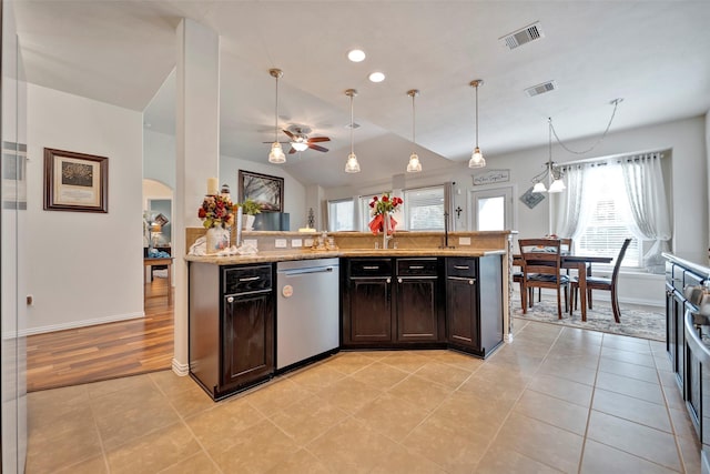 kitchen with ceiling fan, dishwasher, light stone countertops, decorative light fixtures, and light tile patterned flooring