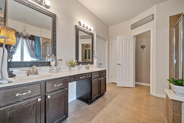 bathroom with tile patterned flooring, vanity, and walk in shower