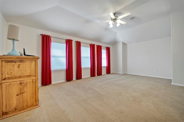 carpeted empty room with ceiling fan and lofted ceiling