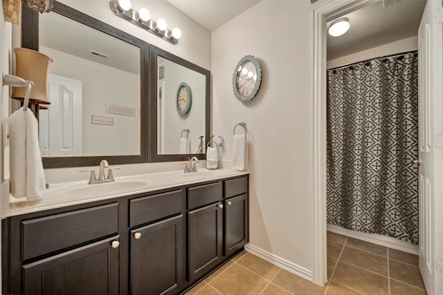 bathroom featuring tile patterned flooring and vanity