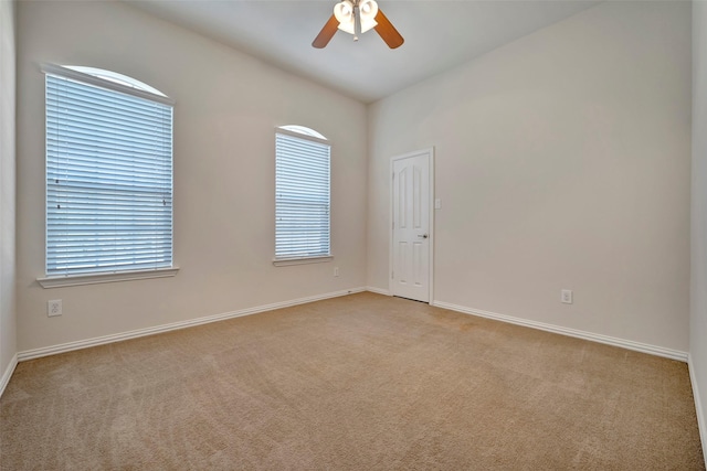 carpeted empty room featuring ceiling fan