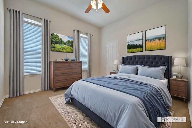 carpeted bedroom featuring ceiling fan and multiple windows