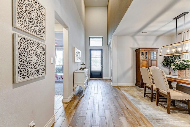 entryway with a towering ceiling and an inviting chandelier