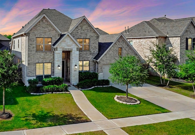 view of front of house with a garage and a yard