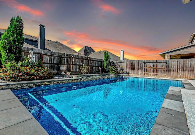 view of pool at dusk