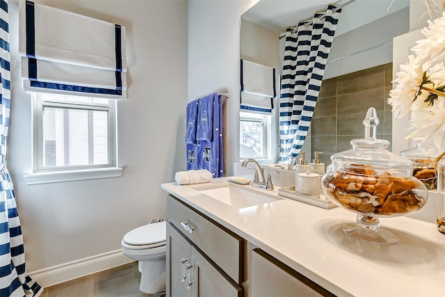 bathroom with tile patterned floors, vanity, and toilet