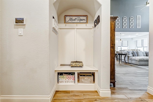 mudroom with a high ceiling and ceiling fan