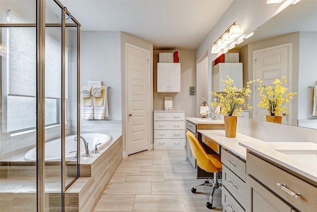 bathroom featuring vanity and tiled tub