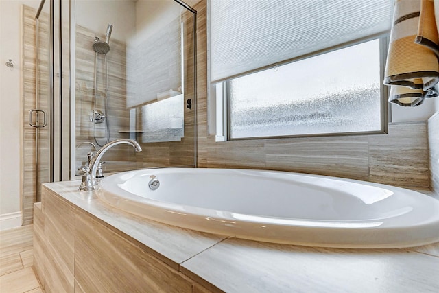 bathroom featuring tile patterned floors and separate shower and tub