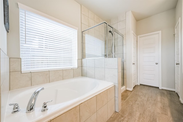 bathroom featuring hardwood / wood-style floors and independent shower and bath