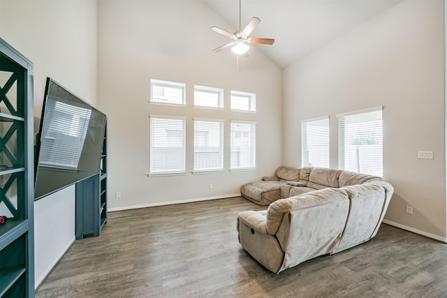 living room featuring ceiling fan, high vaulted ceiling, and wood-type flooring