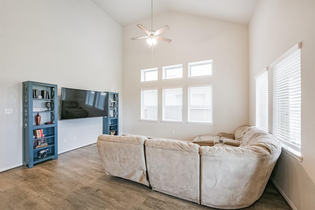 living room featuring hardwood / wood-style floors, ceiling fan, and high vaulted ceiling