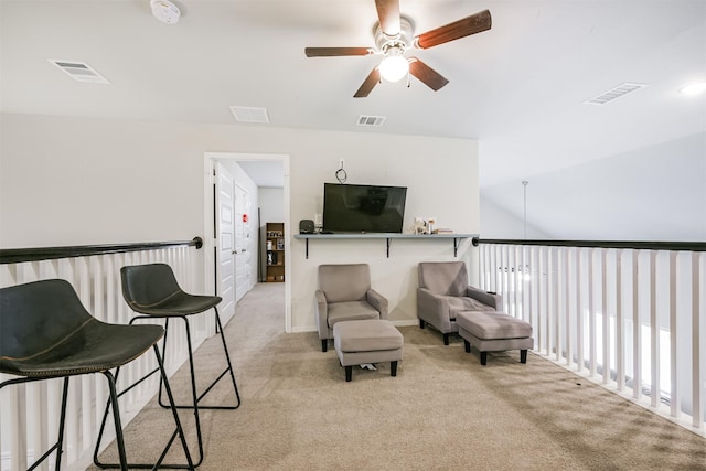 sitting room featuring ceiling fan and light colored carpet