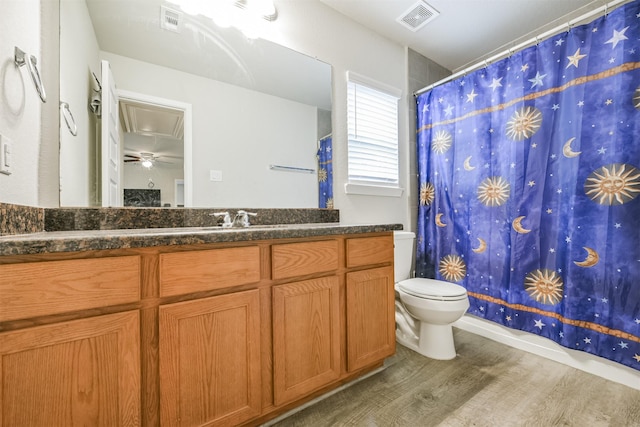 bathroom with hardwood / wood-style flooring, vanity, and toilet