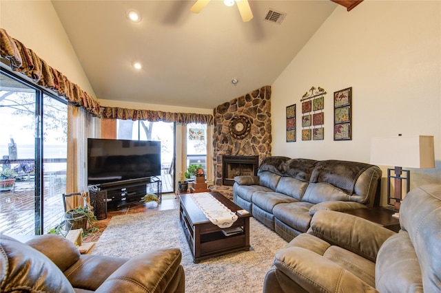 living room featuring a fireplace, plenty of natural light, lofted ceiling, and ceiling fan