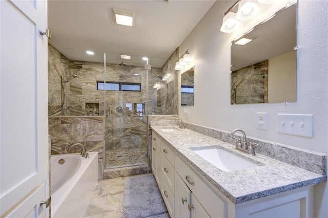 bathroom featuring vanity and separate shower and tub