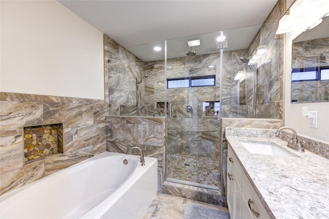 bathroom with plus walk in shower, vanity, and tile walls