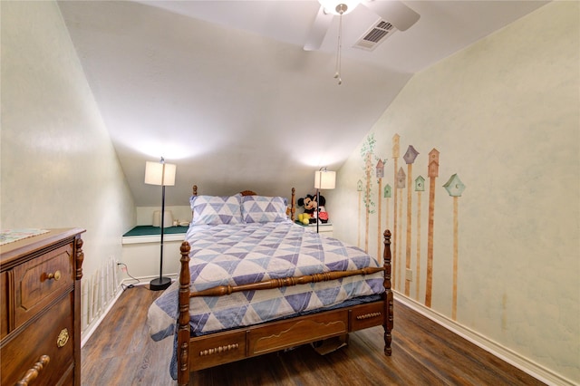 bedroom with dark hardwood / wood-style flooring, vaulted ceiling, and ceiling fan