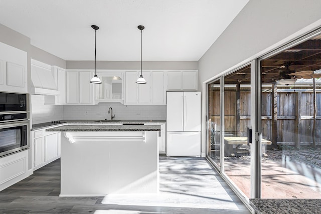 kitchen featuring white cabinetry, a kitchen island, and black appliances