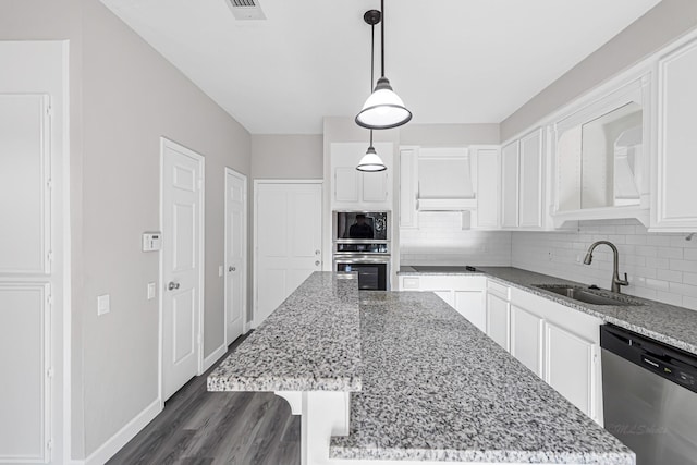 kitchen featuring a center island, white cabinets, stainless steel appliances, and sink