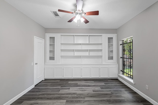 spare room with ceiling fan and dark hardwood / wood-style floors