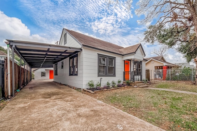 view of front of house with a front lawn and a carport