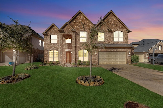 view of front of house with a yard and a garage