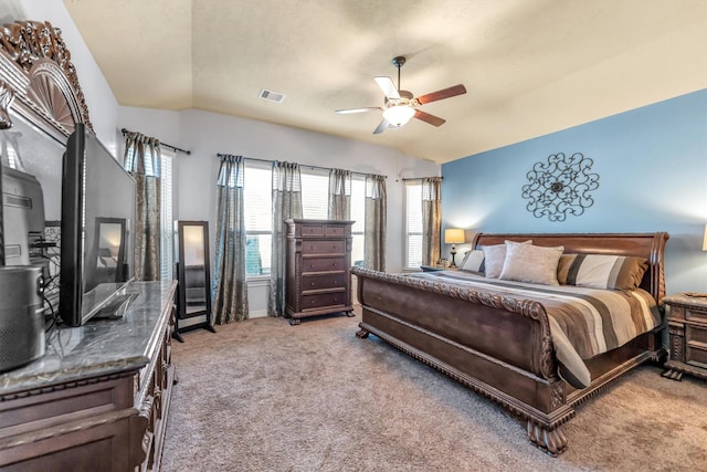 carpeted bedroom featuring ceiling fan and vaulted ceiling