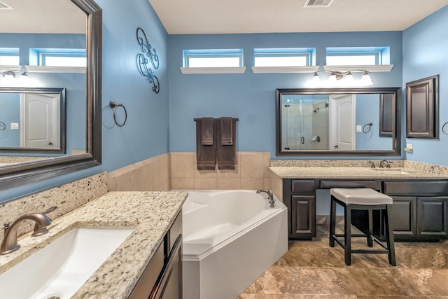 bathroom with a washtub and vanity