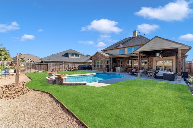 view of swimming pool with a lawn, an outdoor living space with a fire pit, a fenced backyard, and a patio area