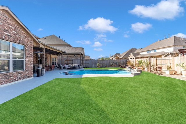 view of swimming pool featuring a lawn and a patio