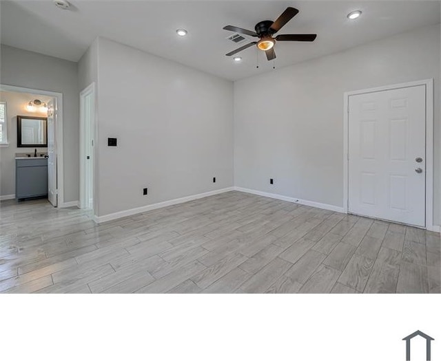 empty room featuring ceiling fan and light wood-type flooring