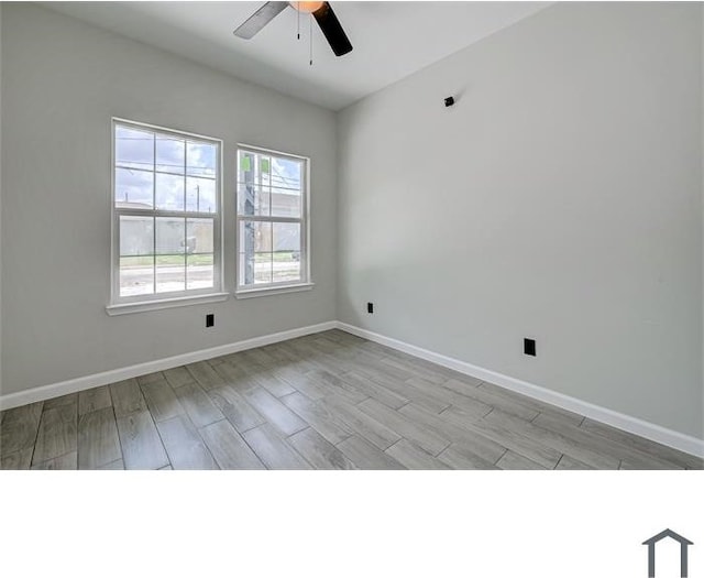 spare room featuring ceiling fan and light hardwood / wood-style floors