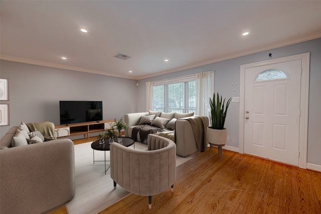 living room featuring light hardwood / wood-style floors and ornamental molding