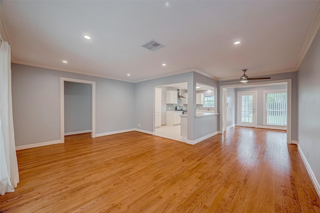 unfurnished living room featuring ceiling fan, light wood-type flooring, and crown molding