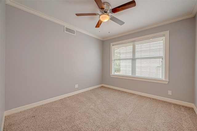 carpeted spare room featuring ceiling fan and crown molding