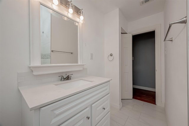 bathroom with decorative backsplash and vanity