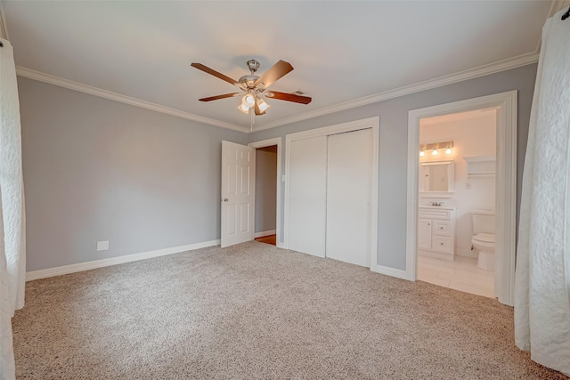 unfurnished bedroom featuring ceiling fan, light colored carpet, ornamental molding, and a closet