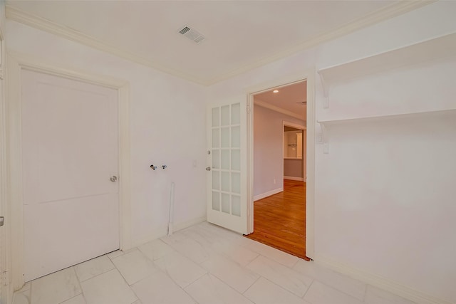 tiled empty room featuring crown molding