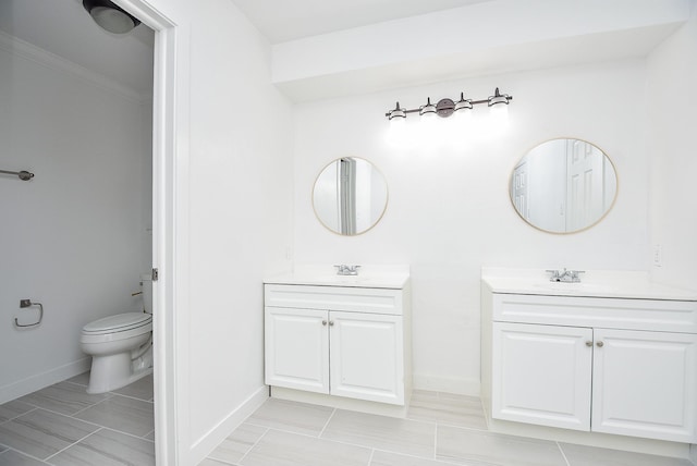 bathroom with vanity, toilet, and crown molding