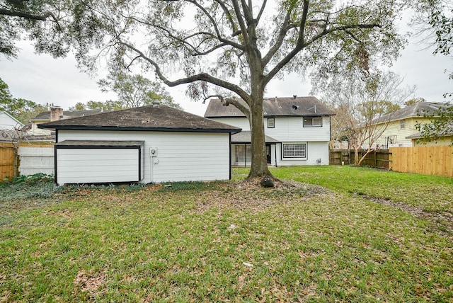 back of house with a lawn