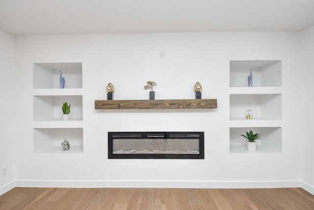 interior details featuring hardwood / wood-style flooring and built in features