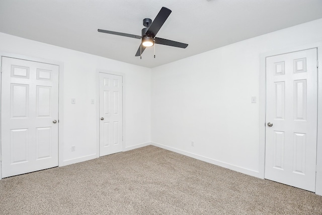 unfurnished bedroom with ceiling fan and carpet floors